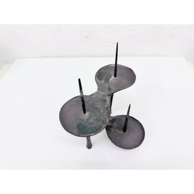 Four-candle holder from the 1970s, designed by Manfred Bergmeister for the Bergmeister metalworks. Hallmark on the...