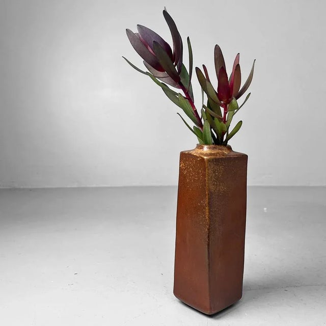 This rare Japanese ikebana vase radiates pure wabi-sabi aesthetics. Handcrafted in earthy brown tones with subtle...