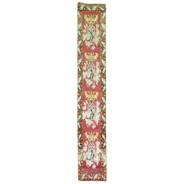 Mid-20th century red field Turkish runner with an all over repetitive flower design. Measures: 1'9'' x 9'10''.