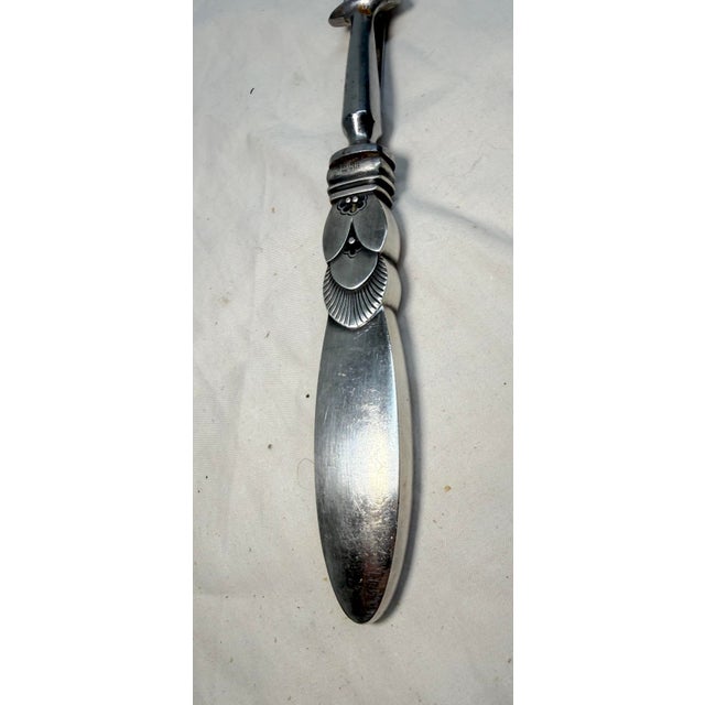 The vintage Georg Jensen "Cactus" pattern sterling silver 2-tine roast carving fork is a stunning piece of Art Deco style...