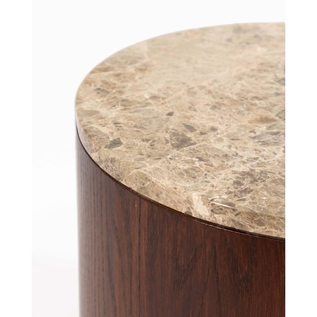 This pair of barrel-shaped end tables in the style of Gio Ponti features a striking combination of richly grained wood...