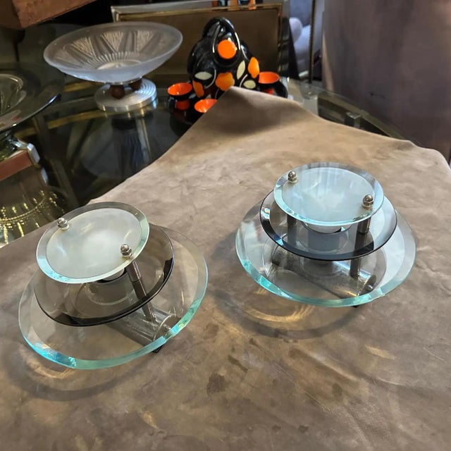 Duo of Iconic 1960s Veca Space Age Italian Wall Sconces - Chromed Metal & Multi-Layered Glass Introducing a captivating...