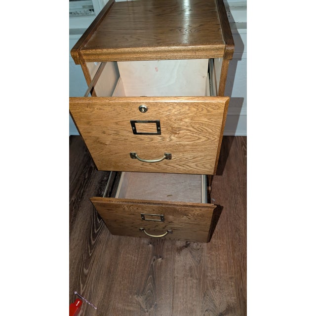 Vintage Solid Oak two drawer filing cabinet. Keys and extra replacement screws come with. Beautiful piece for an office.