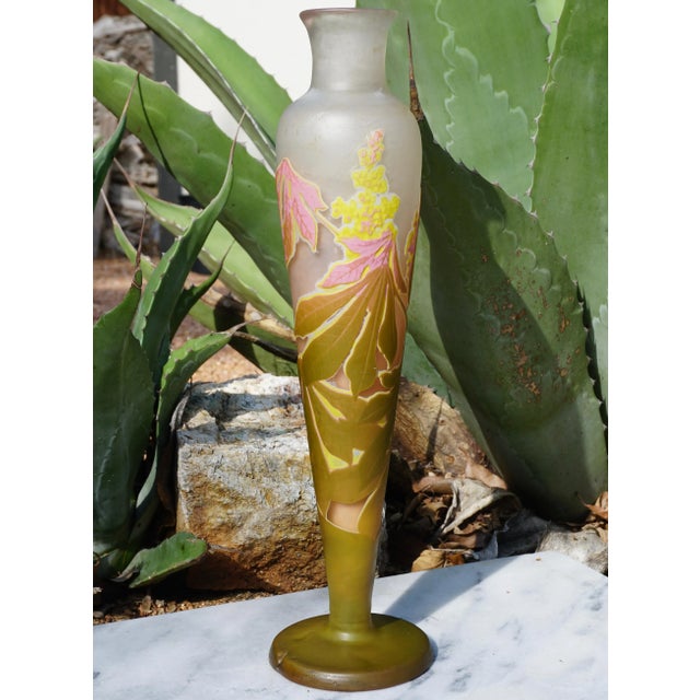 A stunning four color wheel carved and acid etched fat vase with pink, yellow, green and white on a cream background. The...