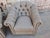 A stylish pair of custom Lexington Robinson swivel lounge chairs featuring a classic tufted back design with rolled arms,...