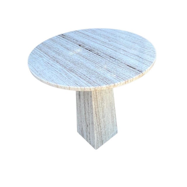 This marble side table features a round tabletop and a geometric-shaped base, offering both style and functionality. Made...