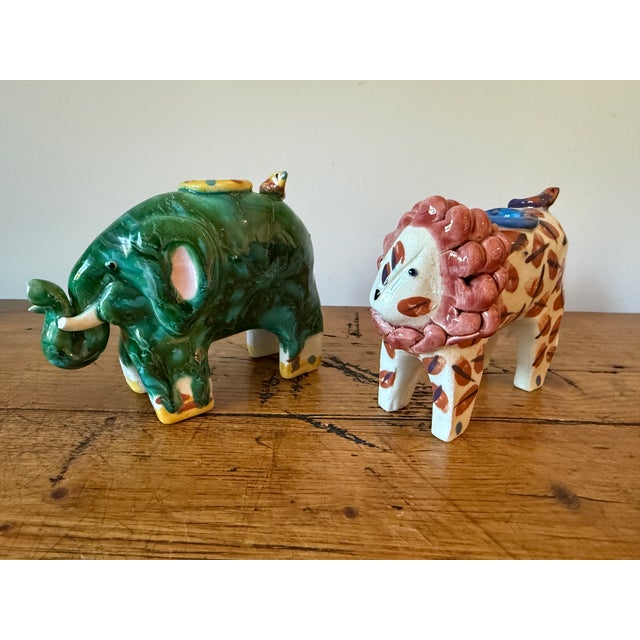 Very Charming Pair of Ceramic Candlesticks ~ 1 Elephant and 1 Lion, Hand Sculpted and Hand Painted. They are similar in...
