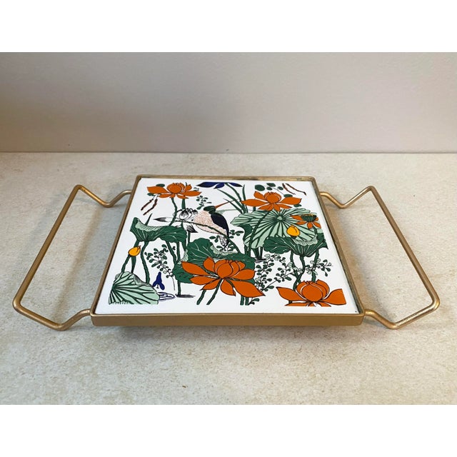 Beautiful boho design of a bird with botanicals. Ceramic tile enclosed in a gold metal frame. Lovely colors!