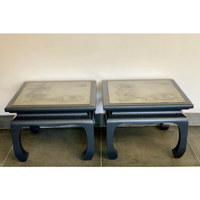 A vintage set of heavy Ming side tables with an inlaid, engraved metal top. The tables are made of lacquered wood and have...