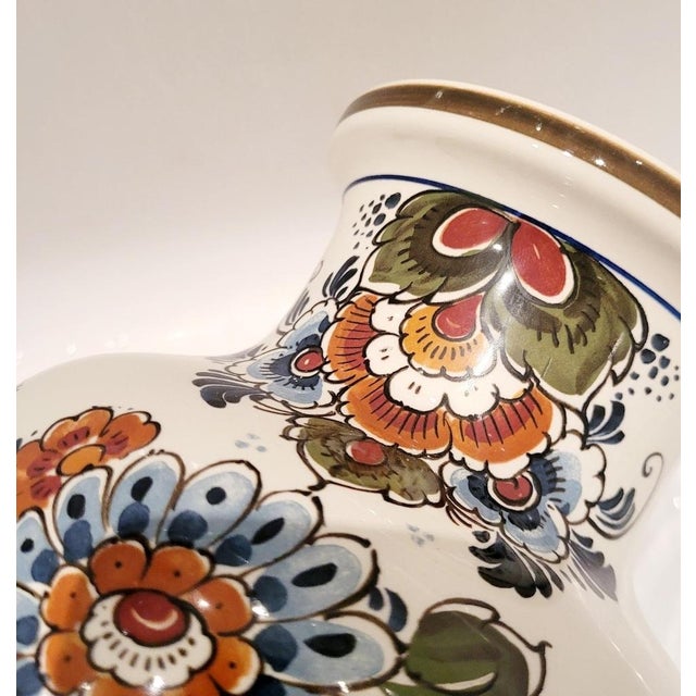 Elegant pair of mid-century Dutch Delft vases by Plateelbakkerij Flora (Gouda), dating to the 1960s. These ceramic vases...