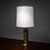 Table lamp by Luciano Frigerio with a brass base and cylindrical fabric shade. The base consists of a disc-shaped foot and...