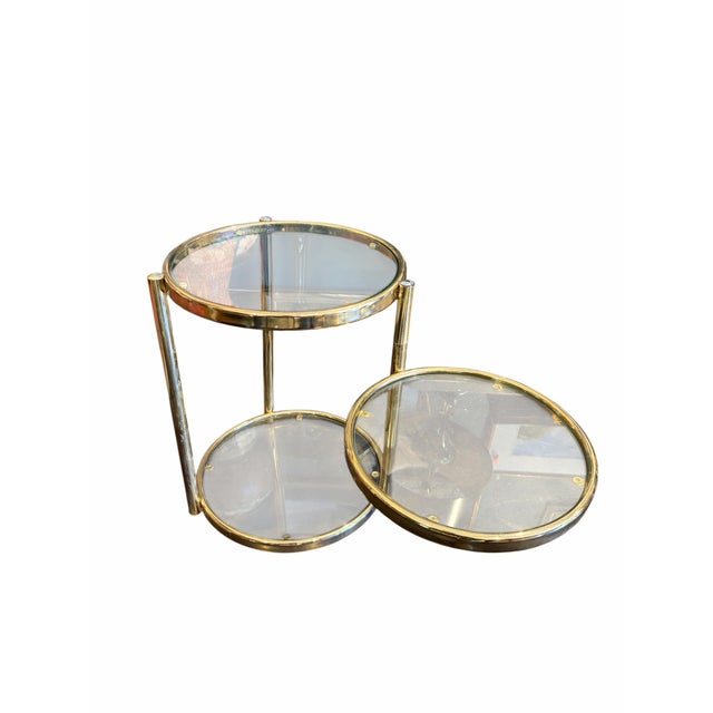 This sophisticated mid-century modern three-tier end table, beautifully attributed to the iconic style of Milo Baughman,...