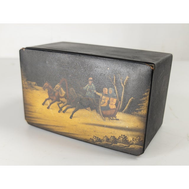We are selling this great early Russian Lacquer box. This lacquer box has simple folky decoration of figures in a horse...