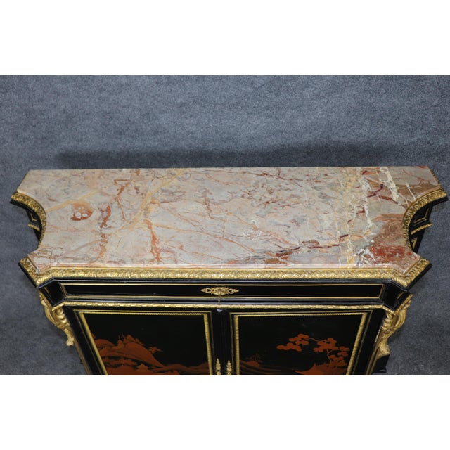 This extraordinary Chinoiserie commode with marble top and gilt bronze ormolu mounts is a stunning example of European...