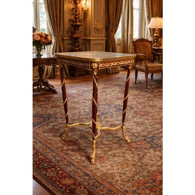 This elegant French side table dates to the 1990s and combines the refined symmetry of Louis XVI design with rich,...