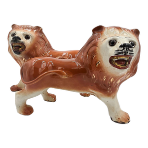 Pair of Staffordshire Striding Lions