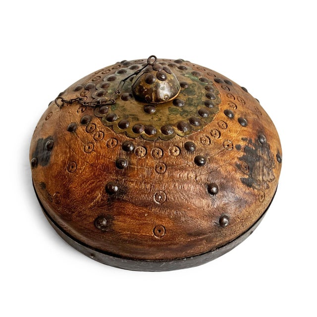 Antique old wooden tobacco container from India. Adorned with brass / metal decorative details. Each is unique and sold...