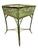 A green painted wicker plant stand with square basket style gallery.