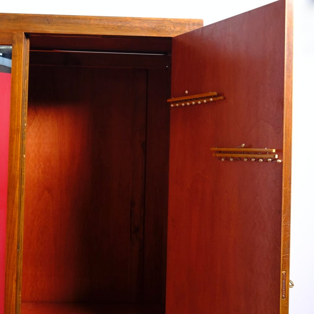 Beautiful 1930s wardrobe in light oak, 1 wooden door and side mirror. Inside, there's a clothes rail and a tie rack on the...