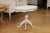 A Swedish painted wood oval top pedestal table circa 1860 with carved undulating apron, turned pedestal and quadripod...