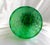 This is a very tall green Murano vase with cut to clear circles all around it. The base looks yellow and, according to...
