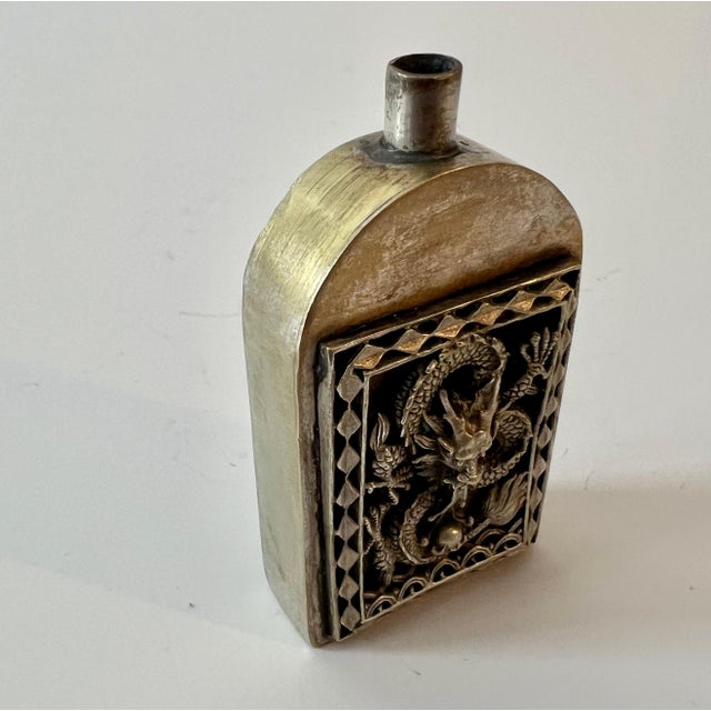 A wonderful unpolished silver Chinese perfume bottle with a dragon repousse... currently the top is missing, however this...