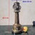 A patinated bronze clock depicting a lighthouse with architectural decoration: the shaft is adorned with windows and...