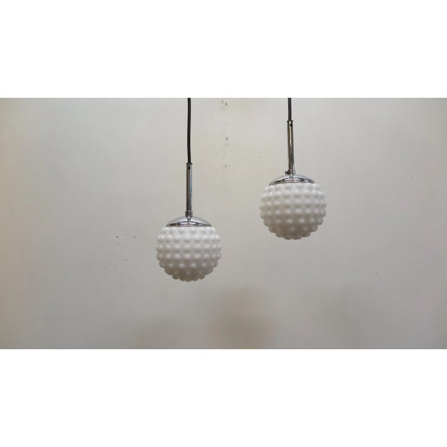 Pair of Mid-Century Modern Snow Ball pendant Lights with bubble texture. Frosted white molded glass snow ball pendants,...