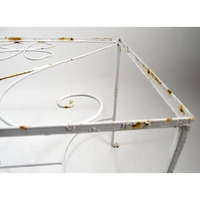 Charming decorative wrought iron patio, garden table with playful foliate ironwork top. Design attributed to Frederick...