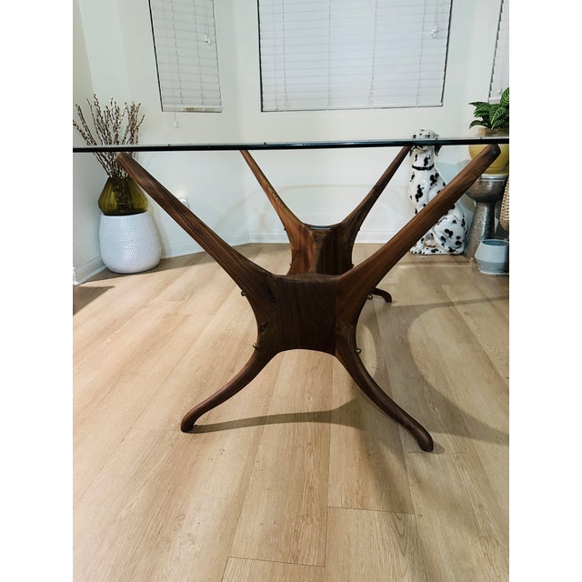 Oblong Beveled Clear Glass 62” Table With a “Organic Modernism" Faux Wooden Metal Base Dimensions: 62”L x 42”W x 28”H...