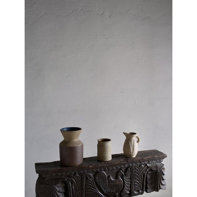 Set of beige stoneware vases with unglazed and matt-glazed surfaces. Einar Johansen designed the left vase for Soholm in...