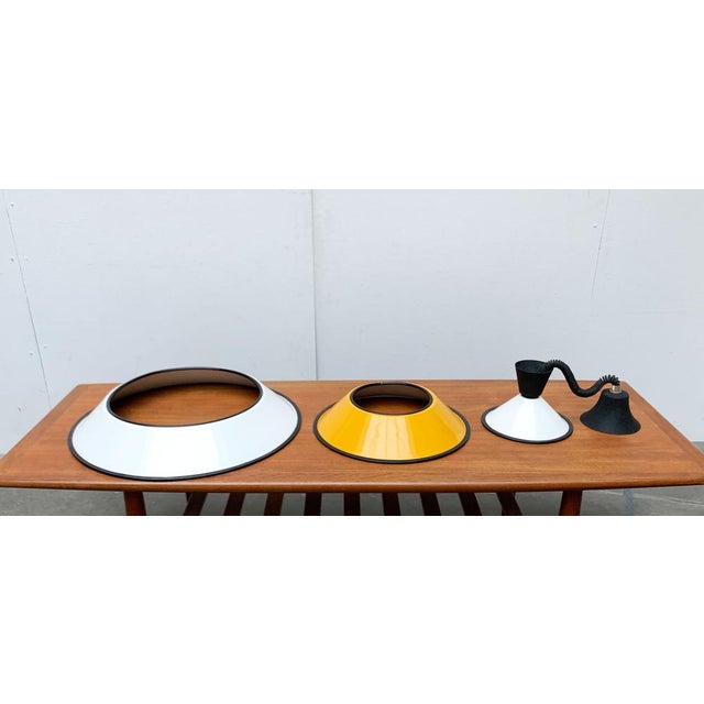 Italian train pendulum with stacked umbrellas. A minimalist and functional design. The lamp screen consists of a...