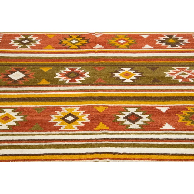 Beautiful Modern Kilim hand-knotted wool rug with a multicolor accents in an all-over geometric design. This rug measures...