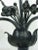 A very special and unique large pair of continental black iron Candelabras—three-arm for large candles--adorned with...