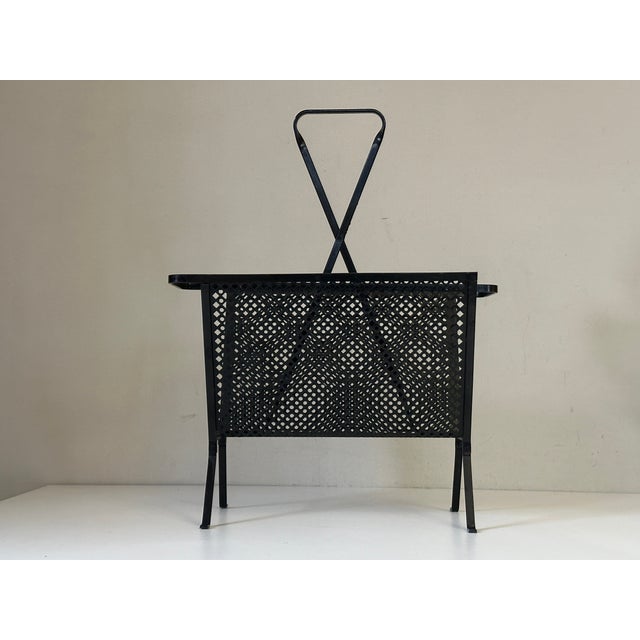 Very elegant and practical metal and perforated metal magazine rack; it is in very good original condition.