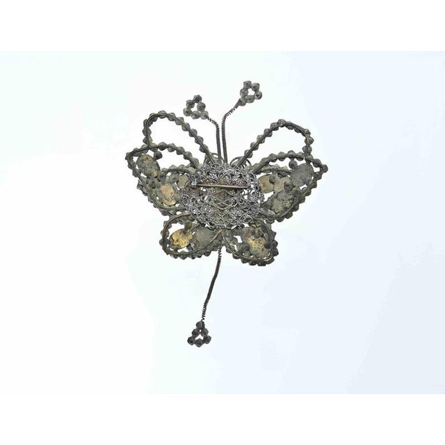 Butterfly-shaped brooch is a handmade object realized in the 1930s. Craftmanship, 17 x 12 cm. Some stones are missing and...
