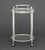 Modern Chrome Plated Two-Tier Bar Cart, the circular glass top with removable glass serving tray on four casters. Overall:...