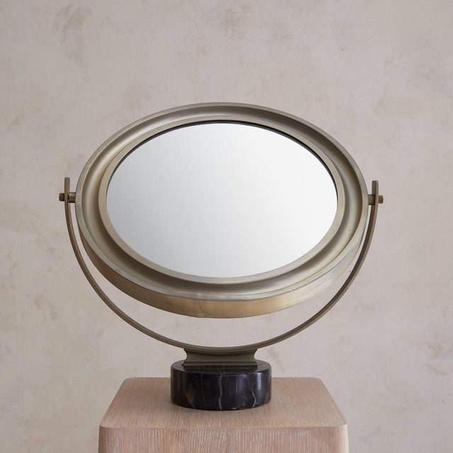 A 1960s Italian table mirror attributed to Sergio Mazza for Artemide. Cast in nickel-plated metal, the round mirror floats...