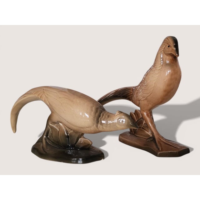 Pair of ceramic pheasants (male and female). Female pheasant: Height 12 cm, Length 32 cm, Width 7.5 cm Pheasant: Height 21...