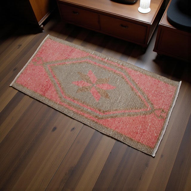 Vintage Turkish hand-knotted small rug from Antep (Southeastern Anatolia), 1970, featuring warm dusty coral tones and...