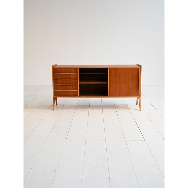 Scandinavian teak sideboard with compartments and drawers with carved handles. Original label from Furulunds Möbelaffär...