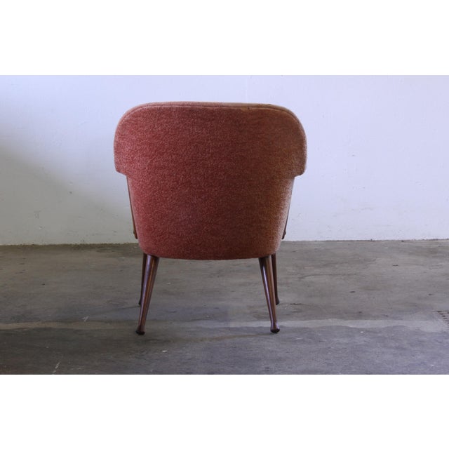 This elegant mid-century armchair embodies the refined craftsmanship and organic lines characteristic of Scandinavian...