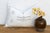 Four star motifs anchor the top of this handcrafted Moroccan cactus silk lumbar pillow, framing a stacked bowtie-diamond...