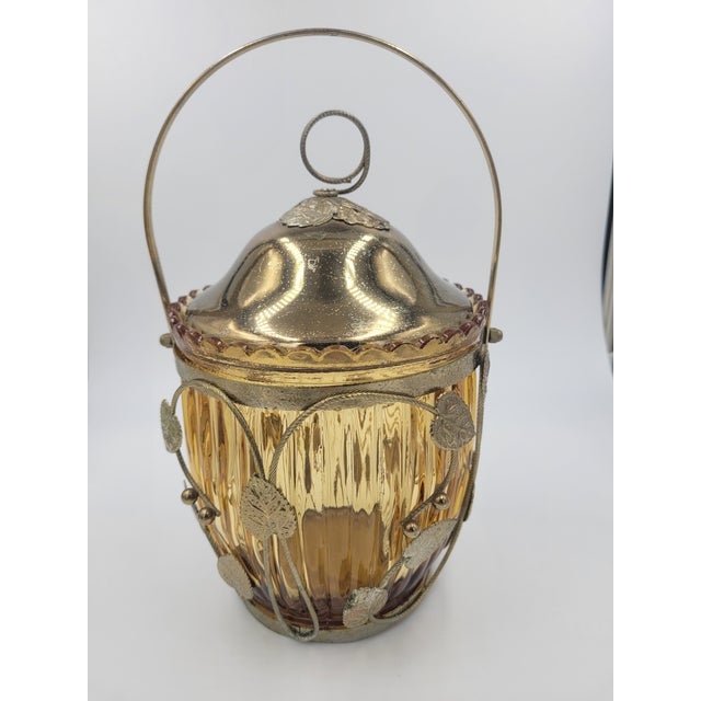 Elevate your bar cart or vanity with this charming Mid-Century Japanese musical biscuit jar. Crafted from warm amber optic...