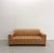 A clean-lined vintage postmodern sofa featuring a tailored silhouette with wide track arms and a fully upholstered frame....