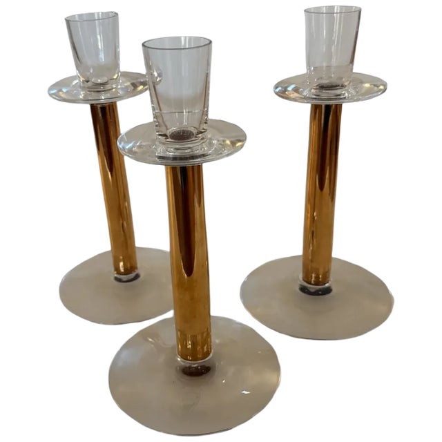 A striking set of three Swedish crystal candlesticks from the Nobel series, designed by Gunnar Cyrén for Orrefors and...
