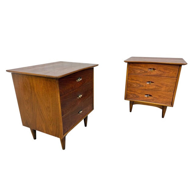 Elevate your bedroom with this stunning pair of Mid-Century Modern Kent Coffey “The Greenbrier” walnut nightstands....