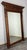 This impressive French mirror presents a grand architectural frame with rich oak detailing, turned side columns and...
