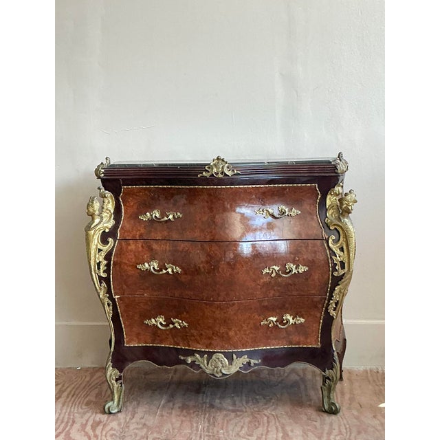 A masterpiece of Rococo exuberance, this exquisite vintage commode embodies the opulence and artistry of the Louis XV...