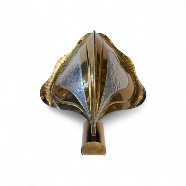 This exclusive pair of wall sconces combines the refinement of gilded brass with the handcrafted texture of embossed...